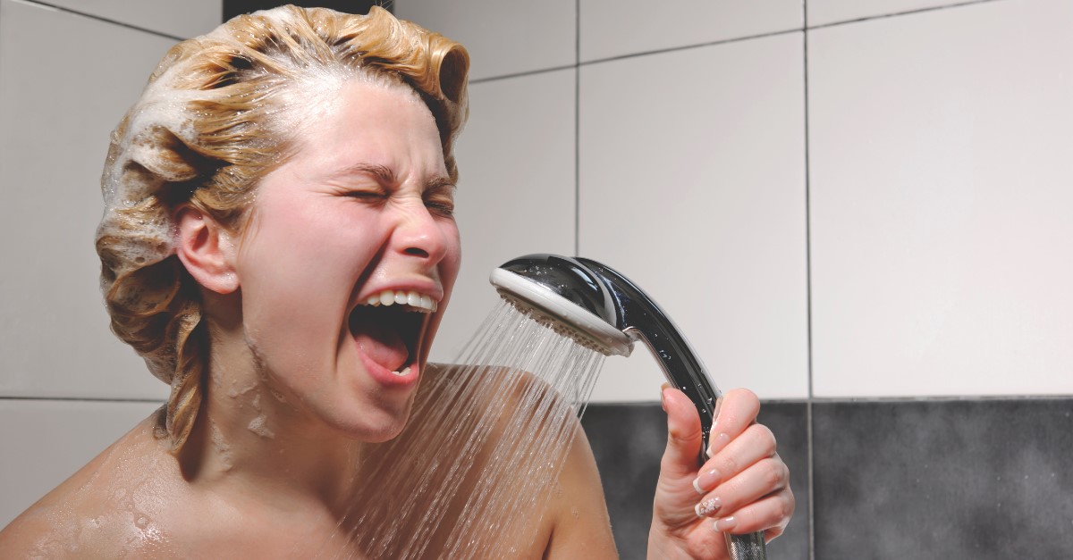 Person singing in the shower while saving water